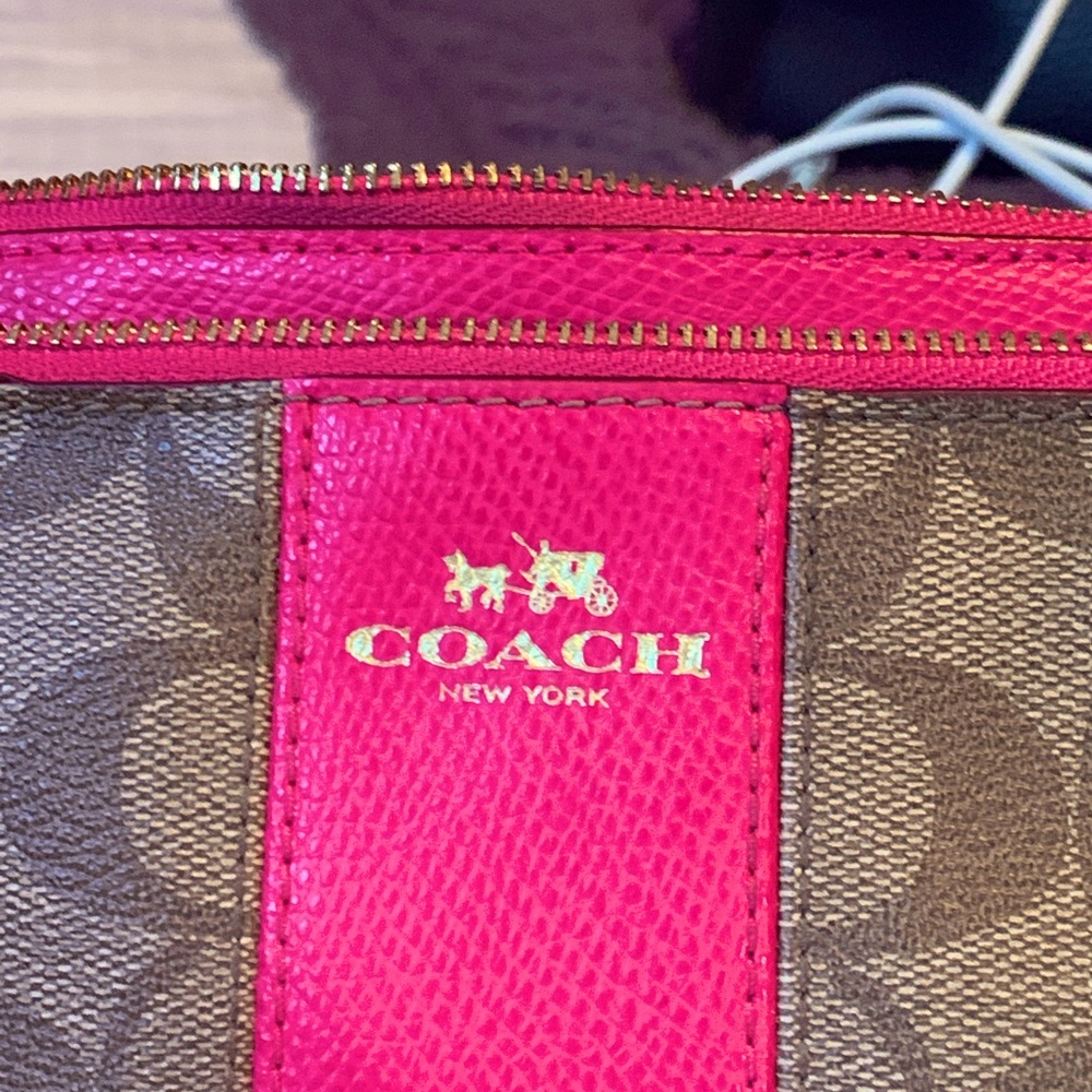 Coach wristlet. Double zip. 1 credit card slot. Brown and pink.